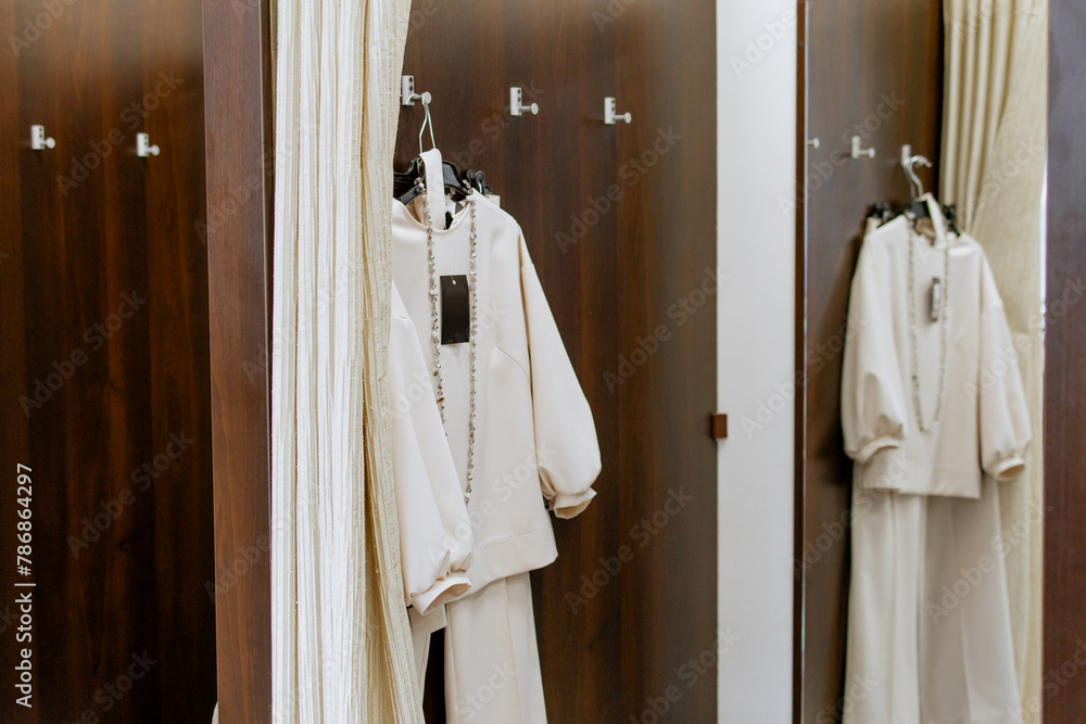 Dressing room with curtains in a clothing store, in fashionable women's clothing store, in boutique. Shopping.
