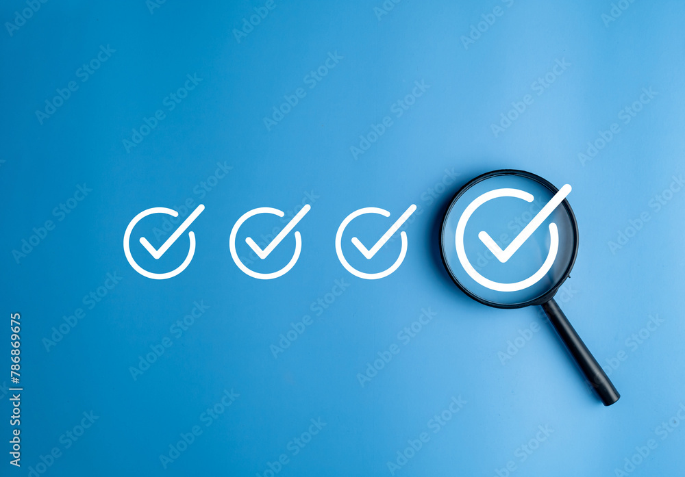 Φωτογραφία Magnifier enlarging the correct or check mark on blue background