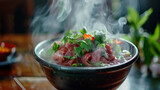 A steaming bowl of aromatic pho soup garnished with fresh herbs and slices of beef