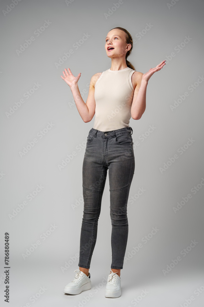 Startled Woman With Surprised Expression on gray background Startled Woman With Surprised Expression on gray background