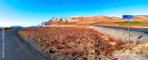 Panoramic over geothermal active zone Hverir in Iceland, near Myvatn lake, Martian landscape, summer and blue sky