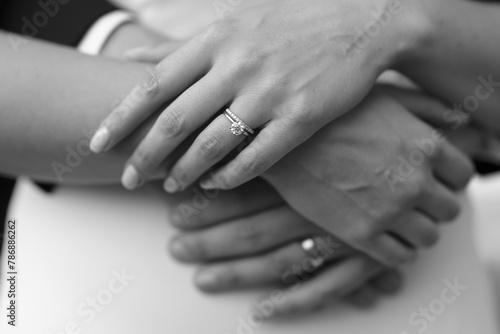 Close-up of wedding bands on bride and groom's hands