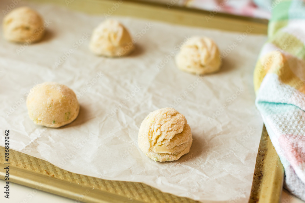 Sugar coated cookie dough on baking sheet Sugar coated cookie dough on baking sheet