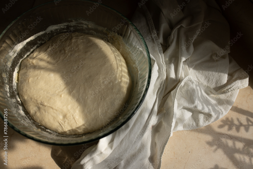 Overhead view of sourdough bread proofing on kitchen counter Overhead view of sourdough bread proofing on kitchen counter
