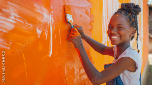 Teenage Girl Creating Colorful Mural with Paint. photo