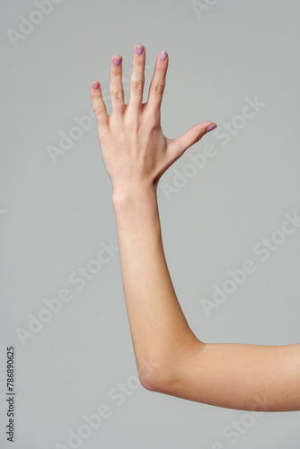 Open palm of a female hand o gray background