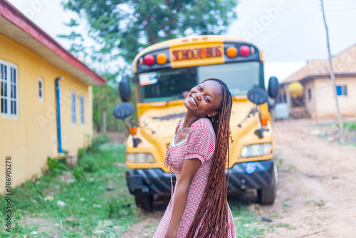 Excited African Female Student with Yellow School Bus, Swinging Braids