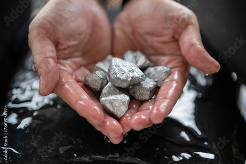 The wet man's hand was holding silver, or platinum, or rare earth minerals