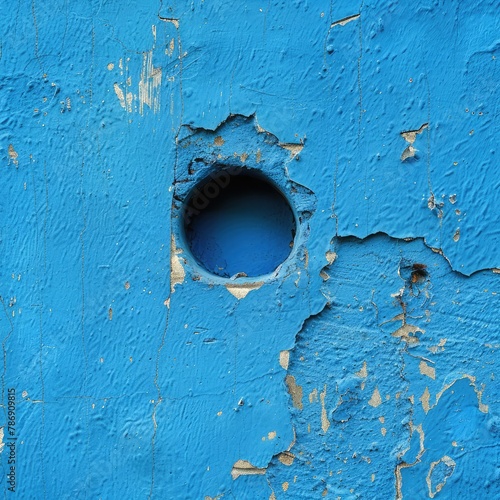 Blue painted wall with hole Blue painted wall with hole