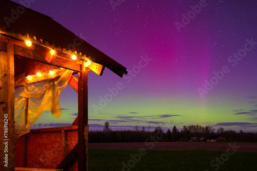 northern lights on a spring night in the middle of the field where the outdoor terrace stands