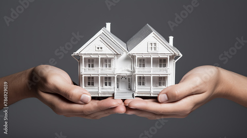 Mortgage concept. Small toy house in business man hand buy or sell real estate Financial agent complete Home sales and home insurance concept 