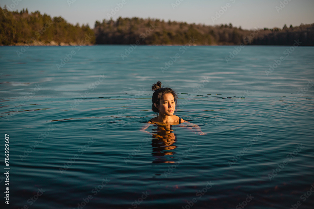 Young asian woman having a bath at lake.jpg