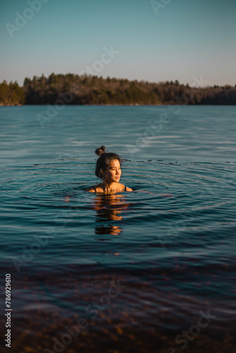 Young asian woman having a bath in a lake.jpg