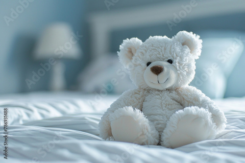 A cute white teddy bear sitting on bed beautiful view