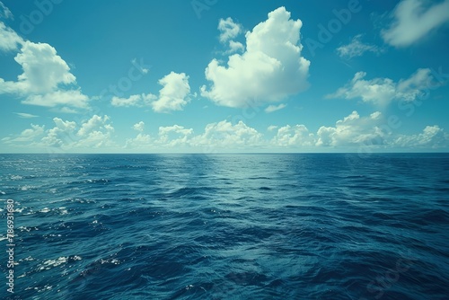 a large body of water under a cloudy blue sky