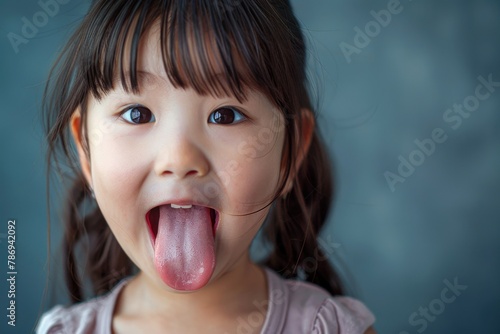 A cheeky little girl with her tongue out. Suitable for children's themes photo