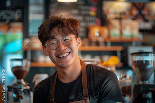 A Korean man with glasses is smiling and holding a coffee cup. Korean male athelete lean muscle barista wearing glasses , in Korean cafe brewing making coffee , smiling , looking at camera