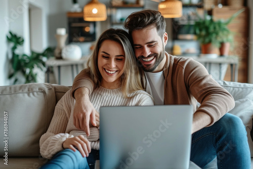Couple relaxing on sofa together, using laptop in cozy living room setting, comfortable home leisure and technology concept