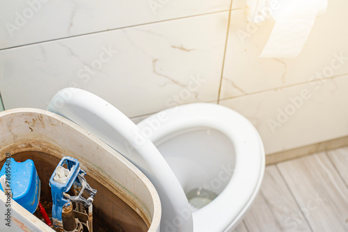 Toilet repair close-up in a home penthouse in a bright cleaning room