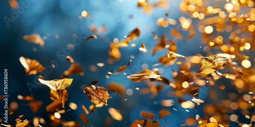 Glittering golden confetti pieces cascade in a celebratory dance against a serene blue backdrop.