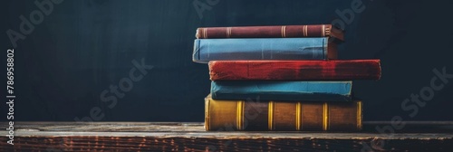 A stack of colorful vintage books on a rustic wooden table, evoking a sense of wisdom and nostalgia.