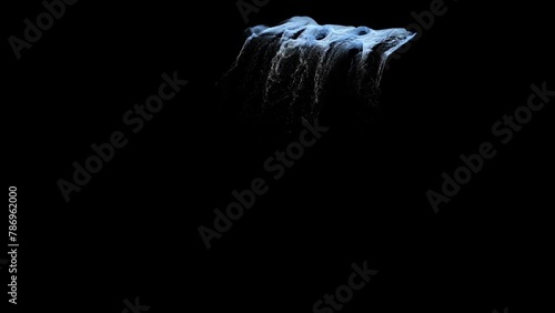 A jet of water pours down from a waterfall on a black background photo