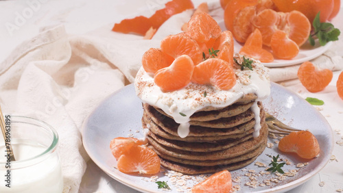 Pancakes with yogurt and tangerines