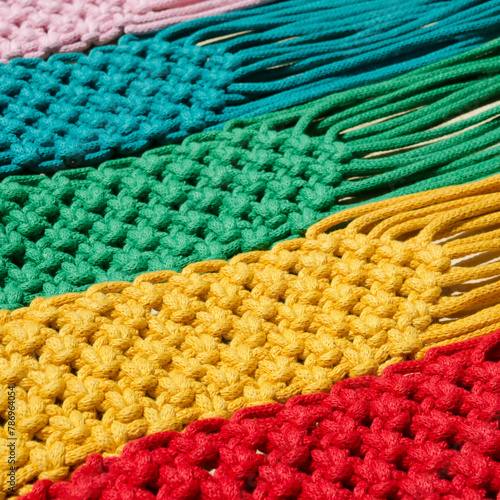 Macrame technique, a square knot of multi-colored threads. © Natalia