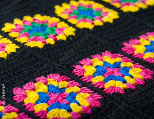 Colorful cotton granny square. Crochet texture close up photo. © Natalia