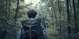 A person walking through a forest with a backpack. Suitable for outdoor and adventure themes
