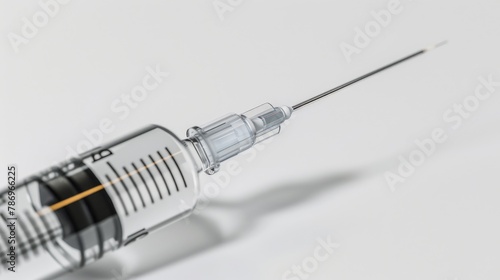 A syringe with a needle stuck in a red apple. Suitable for health and safety concepts