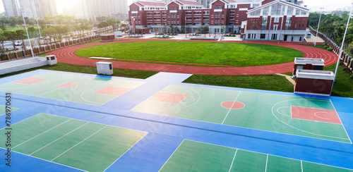 School sport field with basketball court and track © xy