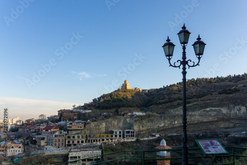 Evening view of Holy Trinity Cathedral of Tbilisi, Georgia from Narikala fortress. Bright sky and clouds.