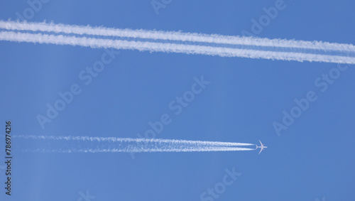 two double airplane tracks in the blue sky