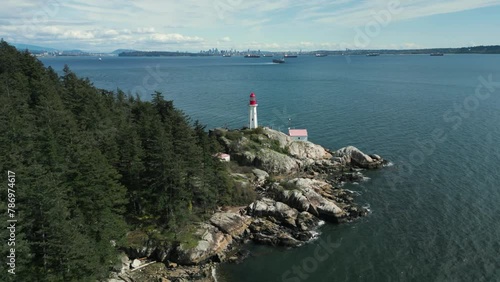 aerial view around point atkinson lighthouse in lighthouse park in west vancouver on an partially cloudy day, british columbia, canada photo