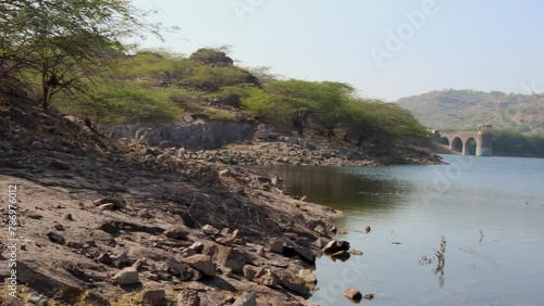 pristine lake calm water with mountain background at day from different angle video is taken at kaylana lake jodhpur rajasthan india. photo