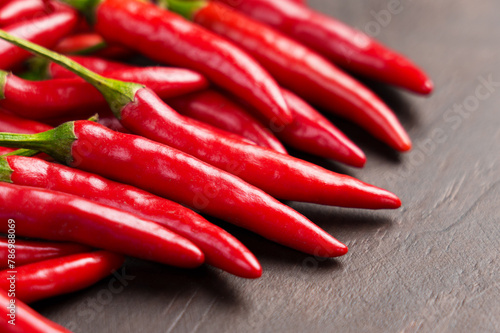 Red hot chili peppers. Organic fresh chilli pods on a wooden surface close up.