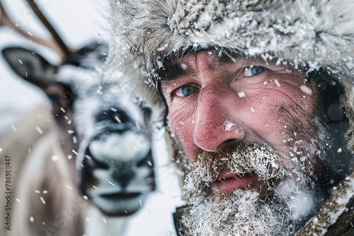 Male reindeer herder in snow photo