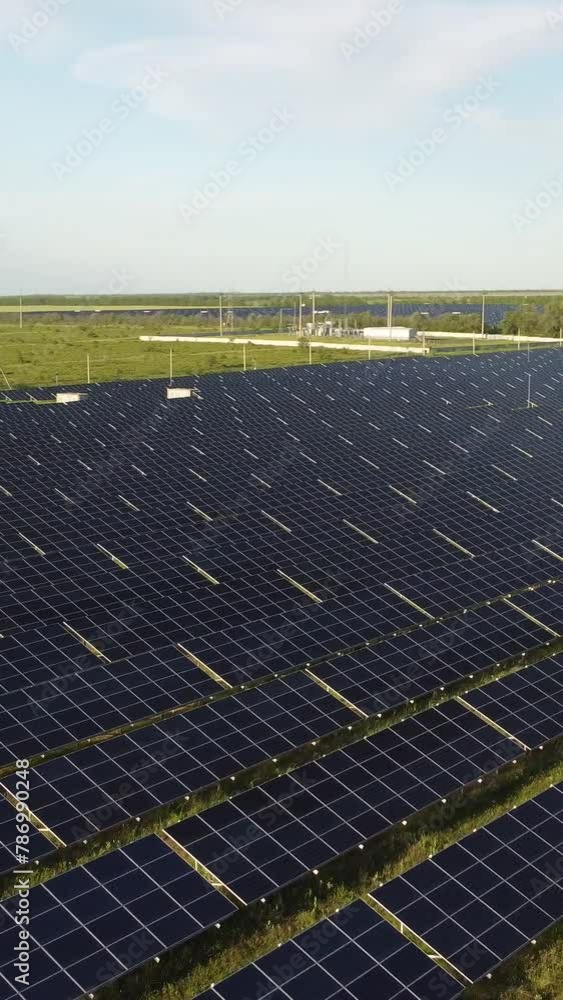 Aerial vertical view of a solar panels power plant. Photovoltaic solar panels at sunrise and sunset in countryside from above. Modern technology, climate care, earth saving, renewable energy concept. Aerial vertical view of a solar panels power plant. Photovoltaic solar panels at sunrise and sunset in countryside from above. Modern technology, climate care, earth saving, renewable energy concept.