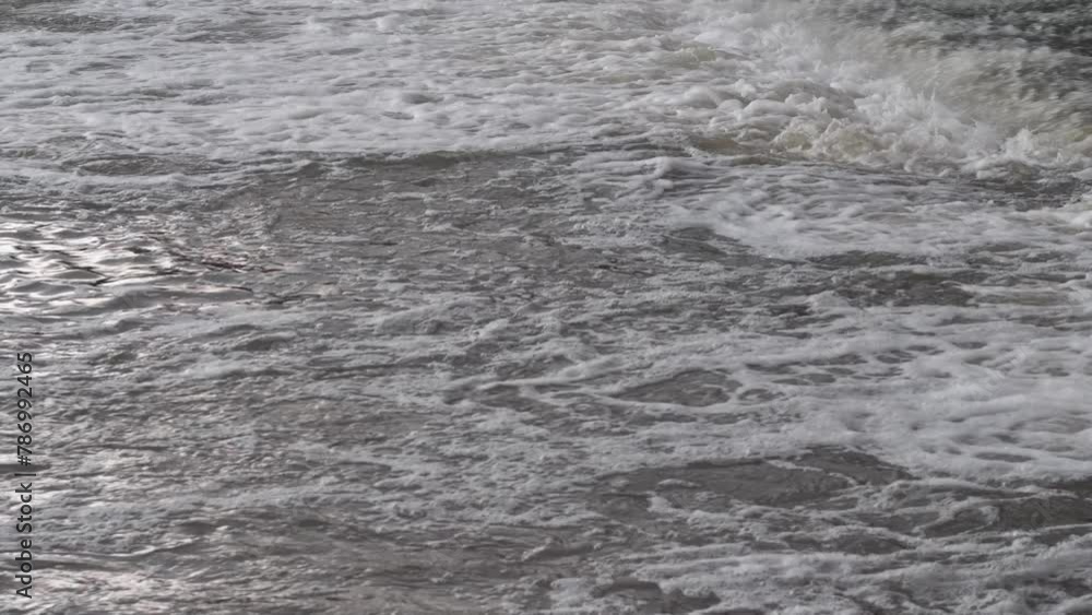 fast flow of a stormy river during spring flood. dam on the river, foot of the waterfall fast flow of a stormy river during spring flood. dam on the river, foot of the waterfall