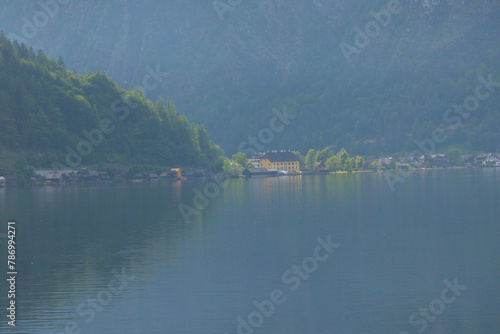 Hallstatter lake near Hallstatt village with cloudy sky in Austrian Alps. Natural colorful evening light on a foggy day. One of the most popular tourist destinations in Austria.