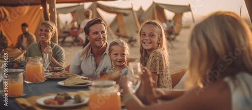 Close up shot of a group of families having Dinner while Glamping