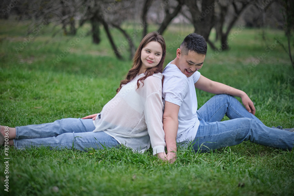 A photoshoot of a young interracial couple with a pregnant wife in nature A photoshoot of a young interracial couple with a pregnant wife in nature