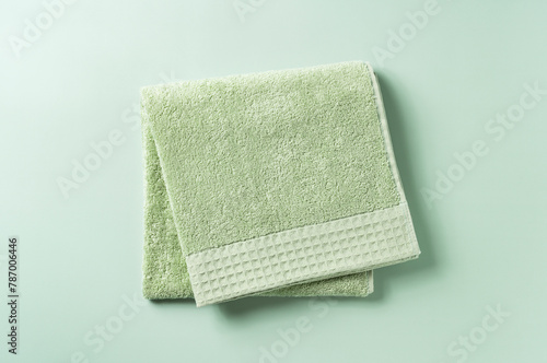 Green towels placed on a green background.