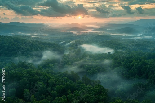 An early morning birds eye view captures misty valleys and rolling hills during a sunrise © Fokasu Art