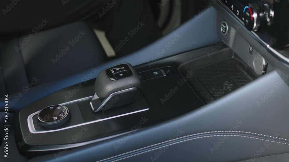 Business woman in her new modern car presses the start button. A middle-aged woman is happy to buy a new car. The concept of modern automotive technology. Business woman in her new modern car presses the start button. A middle-aged woman is happy to buy a new car. The concept of modern automotive technology.