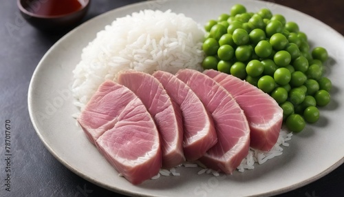 Seared tuna sliced served with rice and green pea