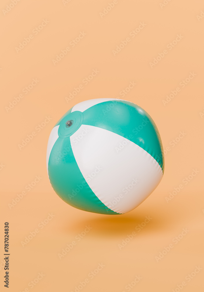 Inflated Beach Ball Floating on Peach Background Inflated Beach Ball Floating on Peach Background
