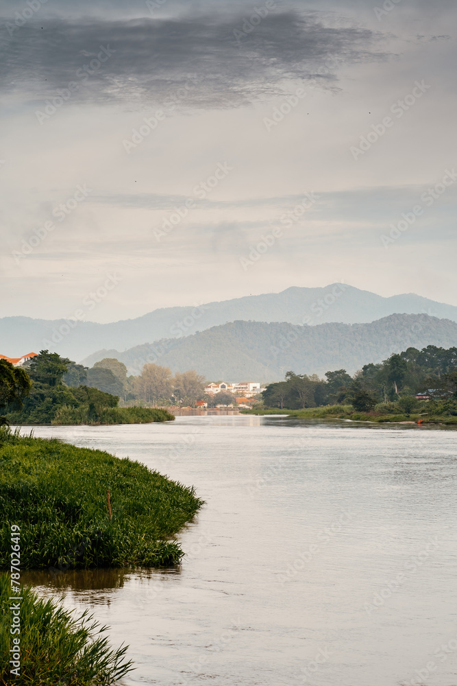Vertical of river banks with wooden boats in Kuala Kangsar, Malaysia