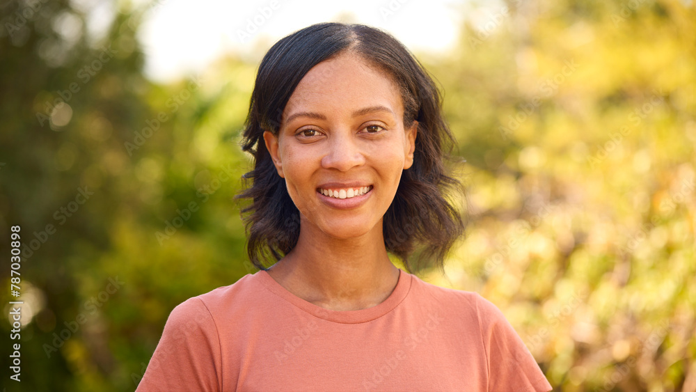 Portrait Of Smiling Woman Standing Outdoors In Summer Countryside Or Garden Portrait Of Smiling Woman Standing Outdoors In Summer Countryside Or Garden